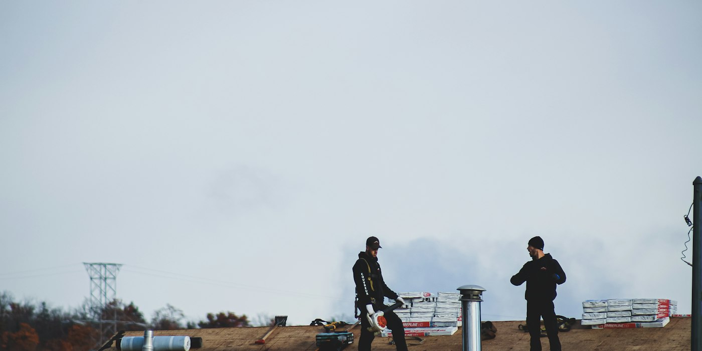 Roofers inspecting a commercial flat roof, Dickson, TN