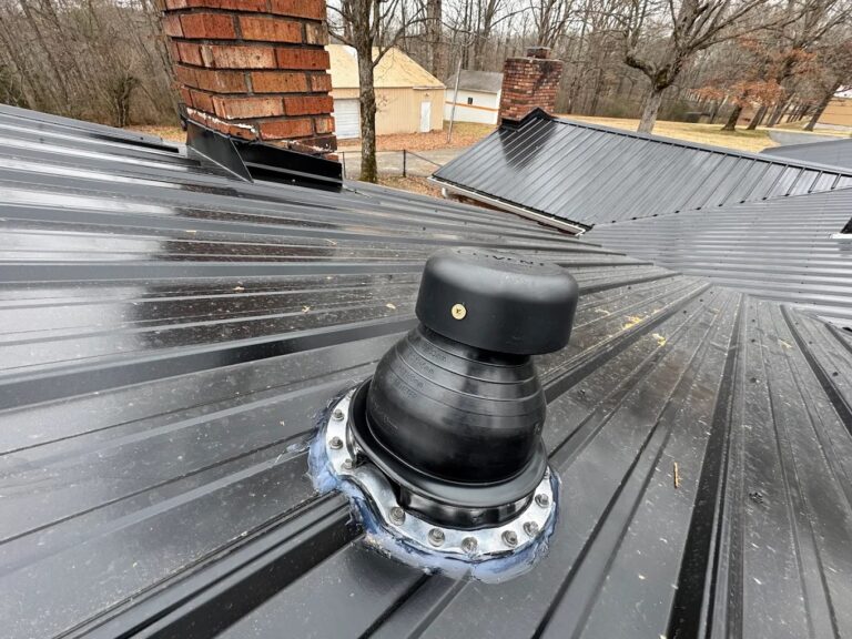Close-up of a metal roof pipe boot