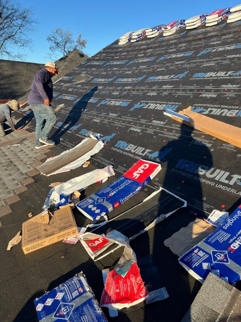Crew installing shingles over new underlayment in Nashville