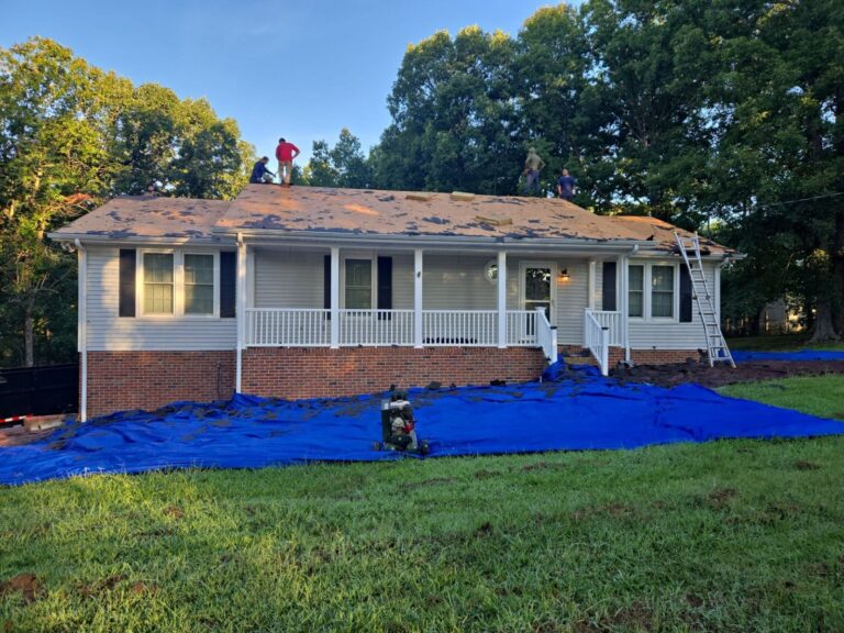 Tarps protecting the yard during a White Bluff tear-off